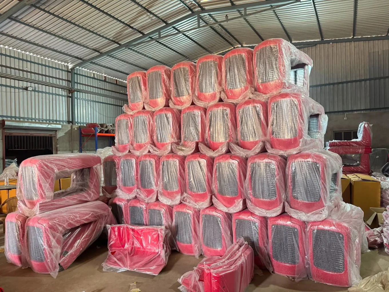 Wrapped tractor body panels stacked at the Ajva Motors factory